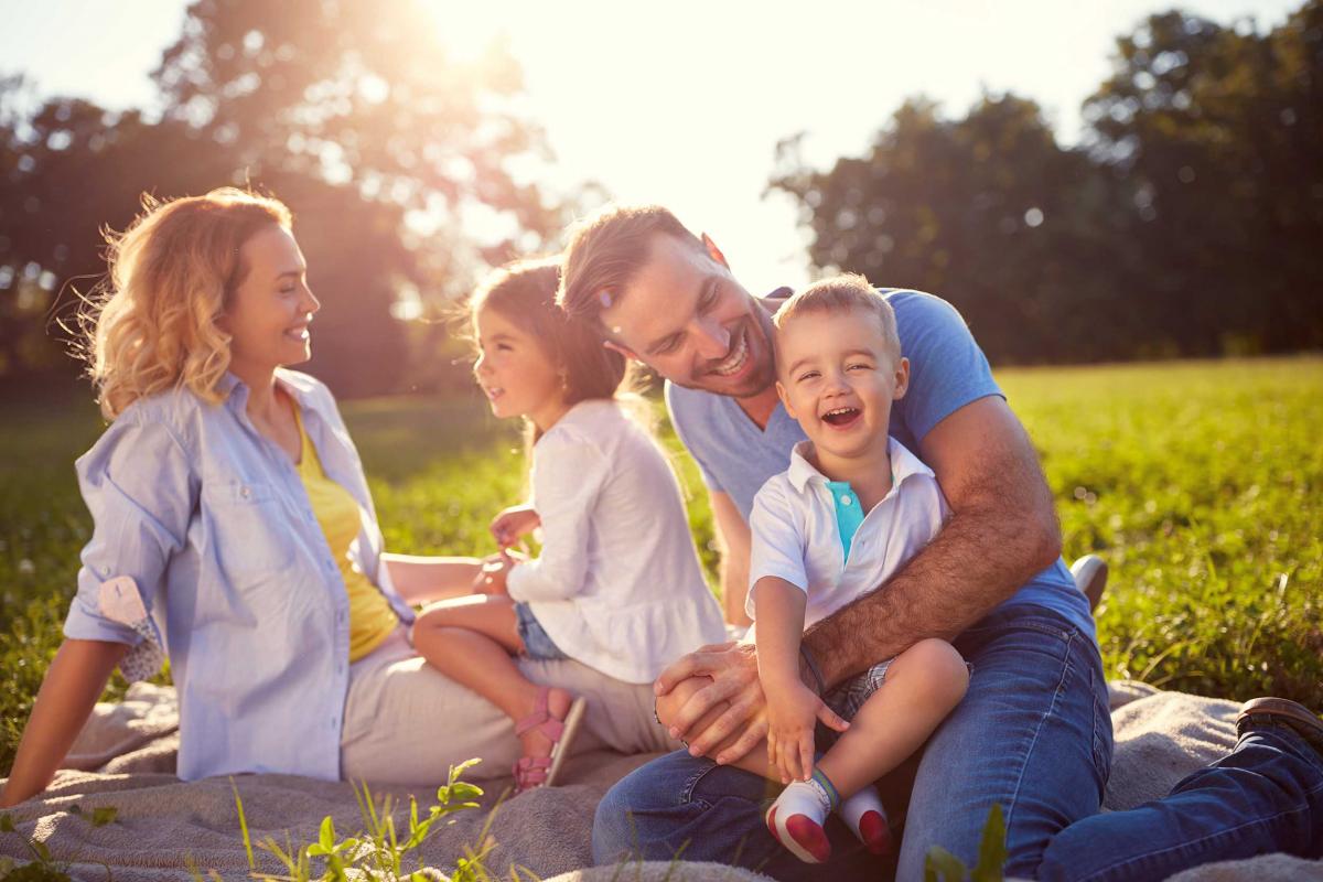 Mum and Dad having a picnic with their children