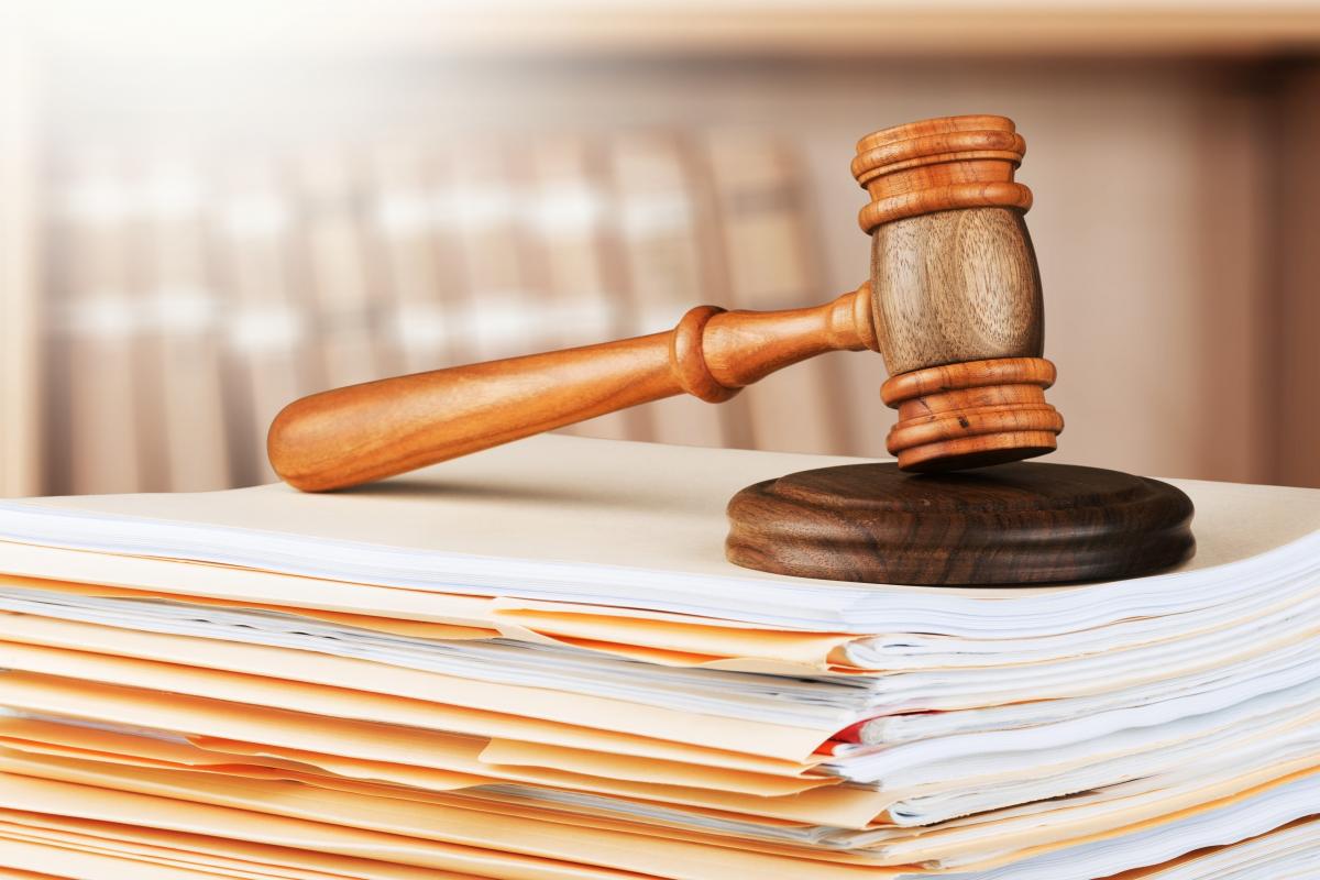 Legal documents with gavel resting on top
